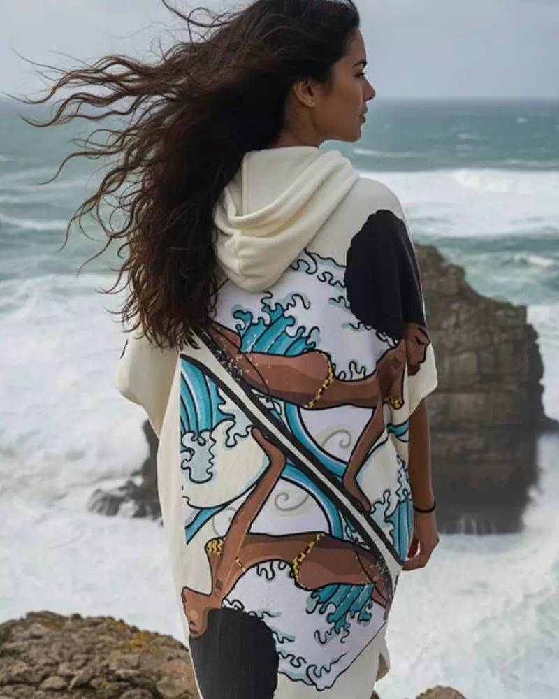 femme en poncho sur une plage 