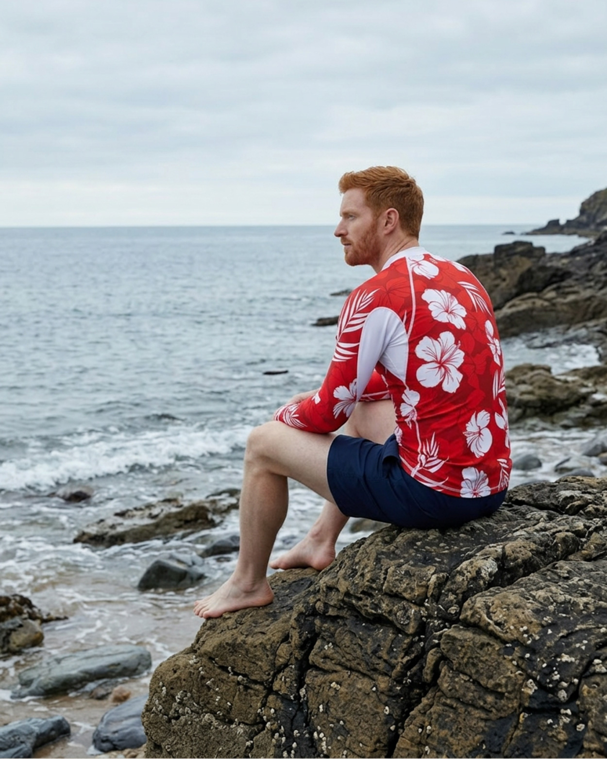 homme portant un tee shirt anti uv rouge sur un rocher de 3/4